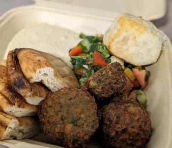 Falafel, pita bread, hummus, Israeli salad, and a potato knish.