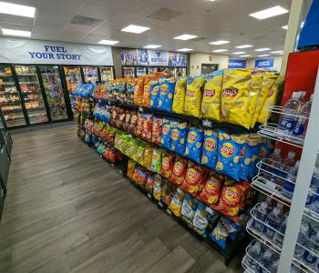 Rows of bagged chips and other snacks in an aisle at the Elli.