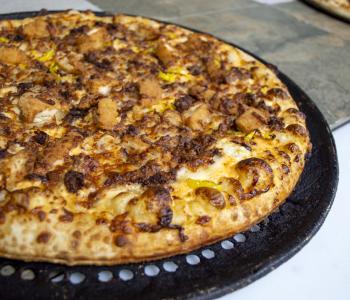 Close up of a whole stinger specialty pizza.