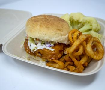 Nashville fried chicken sandwich with seasoned fries and cauliflower.