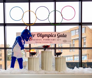 Victor E. Bull lighting the torches under the Olympic rings in the opening ceremony inside C3 Lobby. Photo: Meredith Forrest Kulwicki