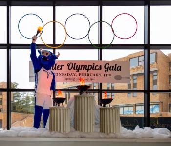 Victor E. Bull lighting the torches under the Olympic rings in the opening ceremony inside C3 Lobby. Photo: Meredith Forrest Kulwicki