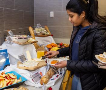 A student at the international cheese selection station next to the dessert station at C3. Photo: Meredith Forrest Kulwicki