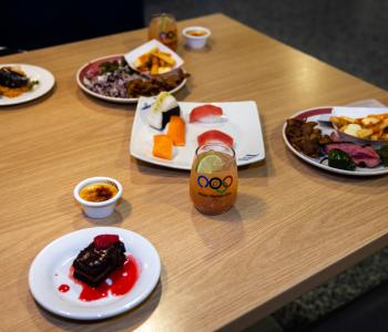 Some plated dishes of the specialized menu items at the event. They include assorted sushi, flank steak, poutine, and desserts like crème brûlée and chocolate cake. Photo: Meredith Forrest Kulwicki